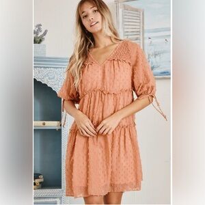 Ces femme boho babydoll dress in rust orange, peach. Textured swiss dot fabric.